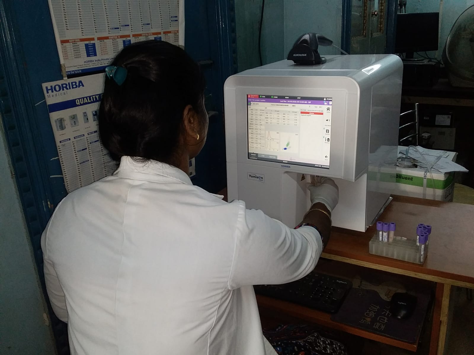 SIAHS student operating a Yumizon hematology analyzer